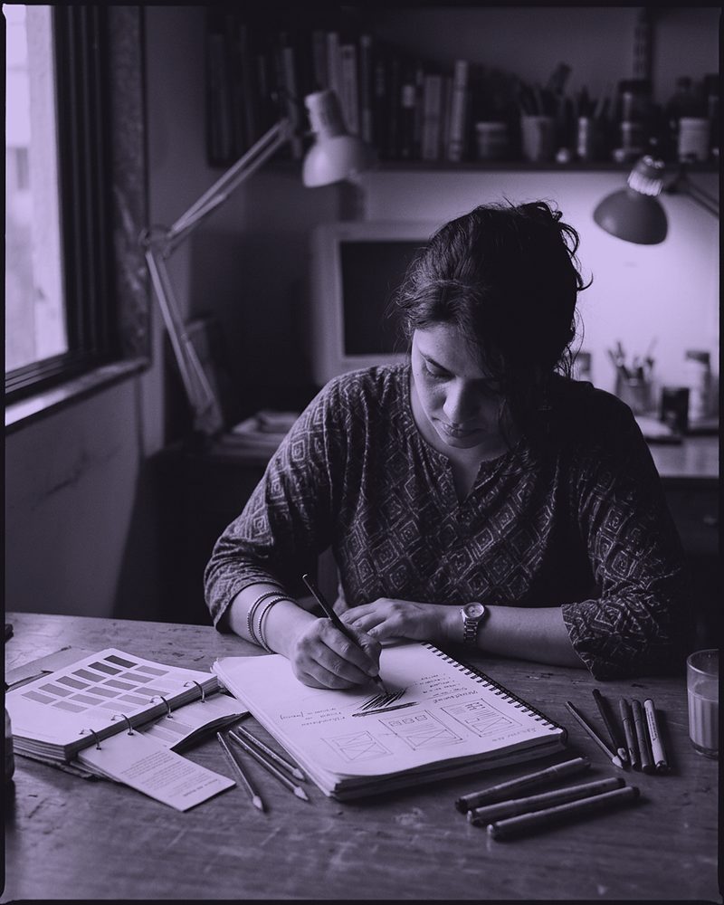A designer sketching at a desk